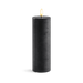 Black candle with a flame on a white background