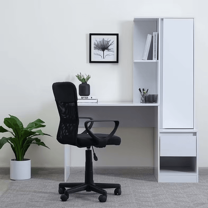 Modern office setup with a black chair, white desk, and storage unit.
