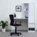 Modern office setup with a black chair, white desk, and storage unit.