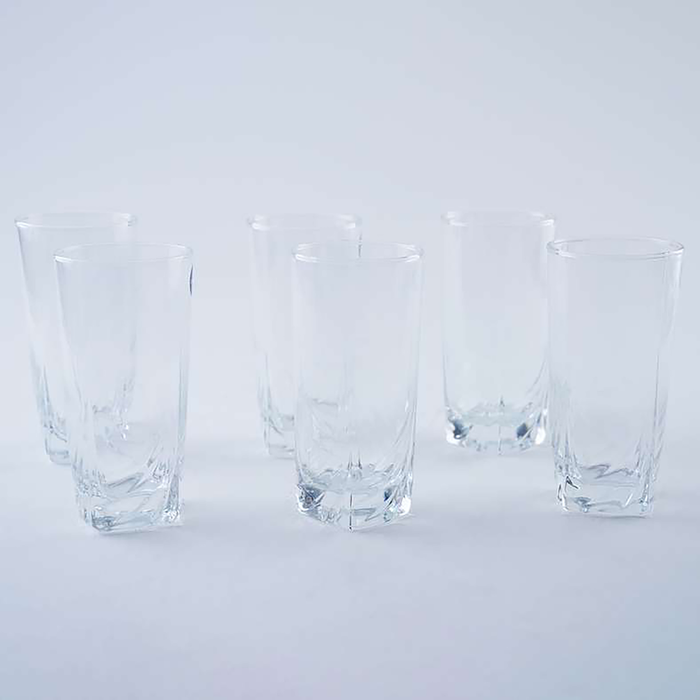 Three clear glass tumblers on a light gray background