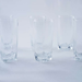 Set of clear glass tumblers on a white background