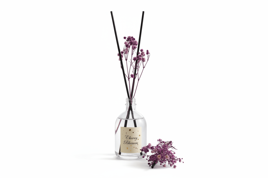 Glass diffuser bottle with floral reeds on a white background