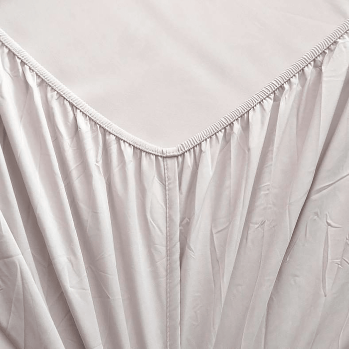 Close-up of a light gray fitted sheet with a subtle texture on a plain background