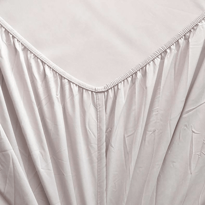 Close-up of a light gray fitted sheet on a bed