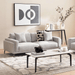 Modern living room with a gray sofa, coffee table, and decorative elements.