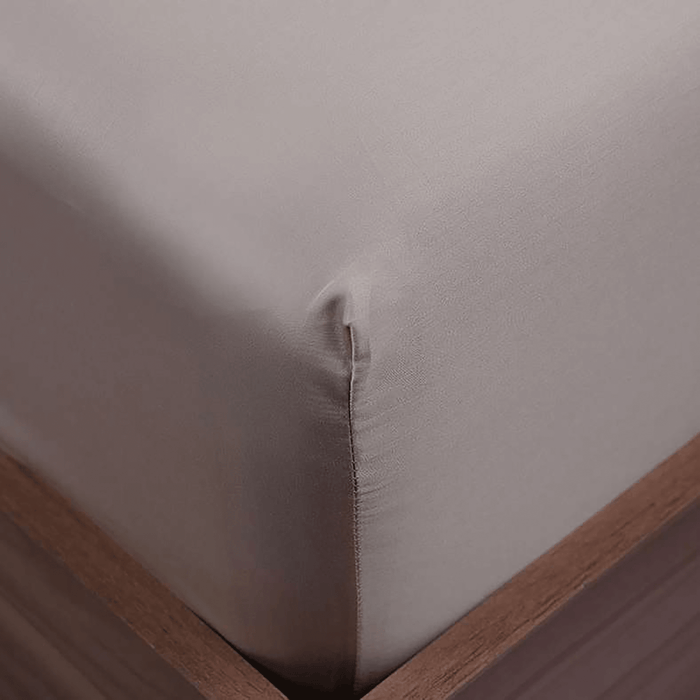 Close-up of a fitted sheet on a bed with wooden frame
