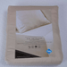 Beige bedding set packaging with visible brand label on a white background
