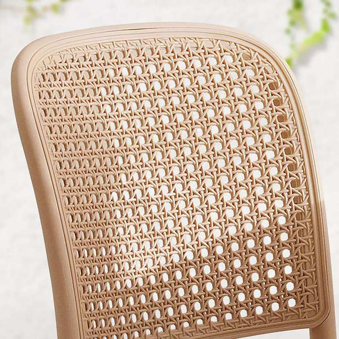 Close-up of a beige wicker chair seat on a light background