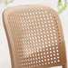 Close-up of a beige wicker chair seat on a light background