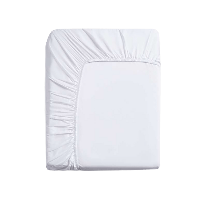 White fitted sheet on a mattress against a green background