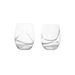 Two clear glass tumblers on a green background