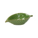 Green leaf-shaped ceramic dish on a white background