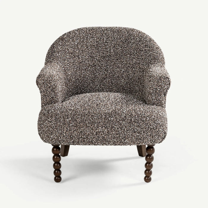 A single upholstered accent chair with a rounded back, rolled arms, and dark turned wooden legs, shown against a plain light gray studio background.