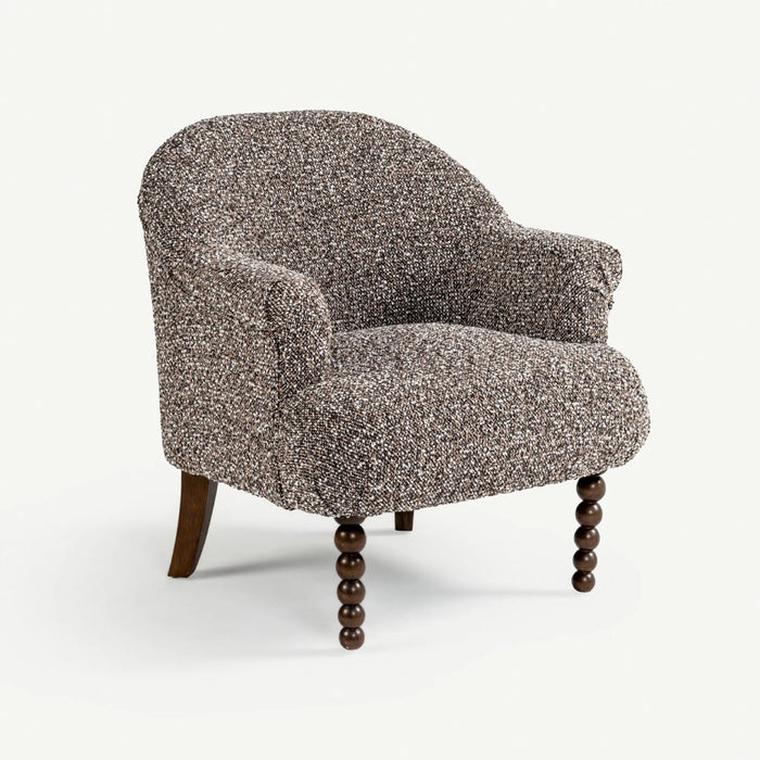 A single upholstered accent chair with a textured speckled fabric in gray, brown, and beige tones, featuring dark wooden turned legs, shown on a clean white background.