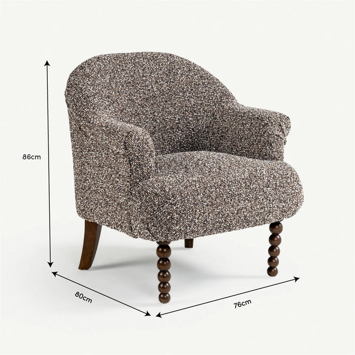 A small upholstered armchair with a textured speckled fabric in gray, beige, and brown tones, shown with dimension arrows and labels indicating 86 cm height, 80 cm width, and 76 cm depth on a light gray background.