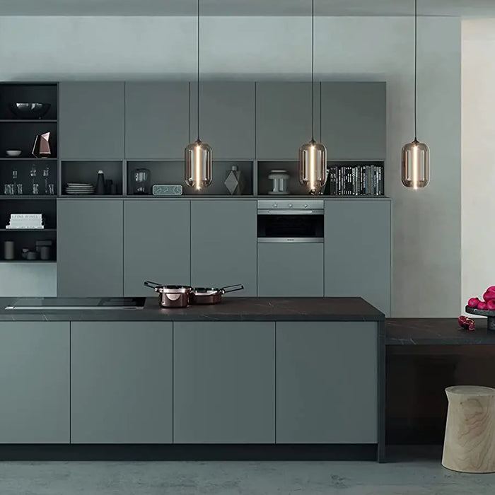 Modern kitchen with dark green cabinets and black countertops