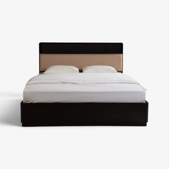 A modern platform bed with a dark wood base and headboard, featuring a beige upholstered center panel and white bedding, shown against a plain white background.