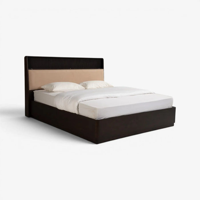 Gray upholstered bed with white mattress on a white background