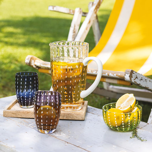 Punch bowl with lemon slices on a table outdoors