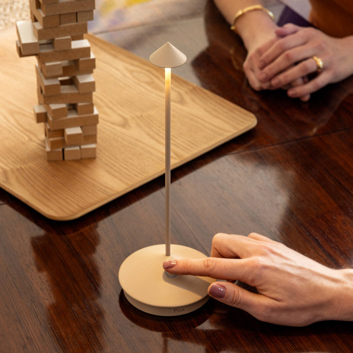 Wooden balance toy with a small lamp on a wooden table