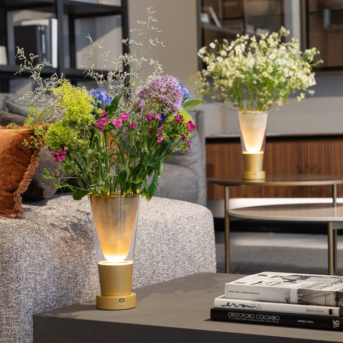 Decorative table lamp with flowers on a coffee table in a living room setting
