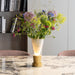 Decorative vase with flowers on a marble table