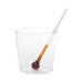 Clear glass with a small spoon on a green background