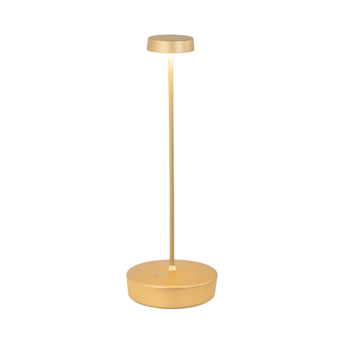 Gold table lamp on a green background