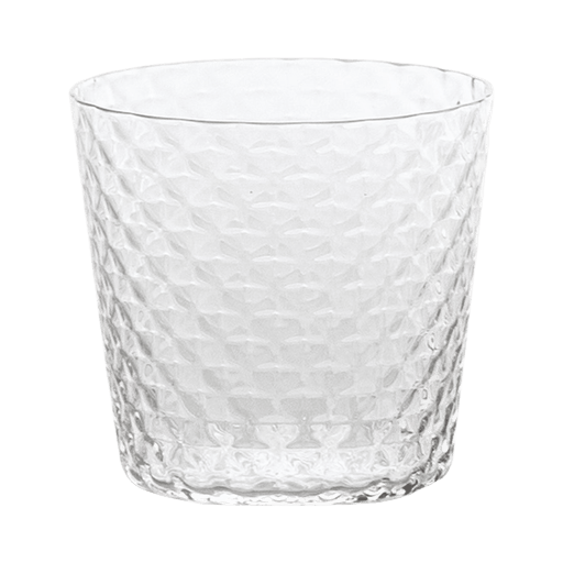 Clear textured glass tumbler on a green background