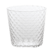 Clear textured glass tumbler on a green background