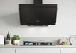 A matte black modern range hood mounted above a gas stovetop in a clean, minimalist kitchen setting with white cabinetry and light gray walls.
