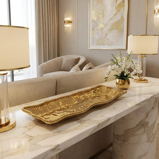 Luxurious living room with marble table, gold tray, and abstract art