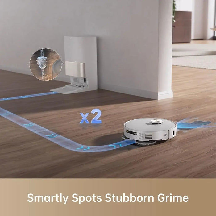 Robotic vacuum cleaner on a wooden floor with cleaning path and text 'Smartly Spots Stubborn Grime'.