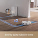 Robotic vacuum cleaner on a wooden floor with a wall-mounted device in the background.