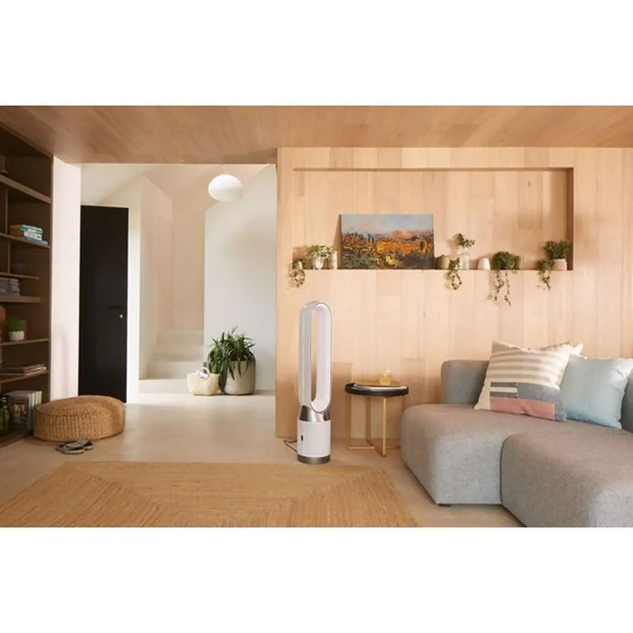 Modern living room with a tower fan, sofa, and decorative elements.