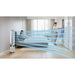 Air purifier emitting a blue light in a modern living room with people in the background