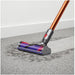 Vacuum cleaner on a carpeted floor with a white wall background