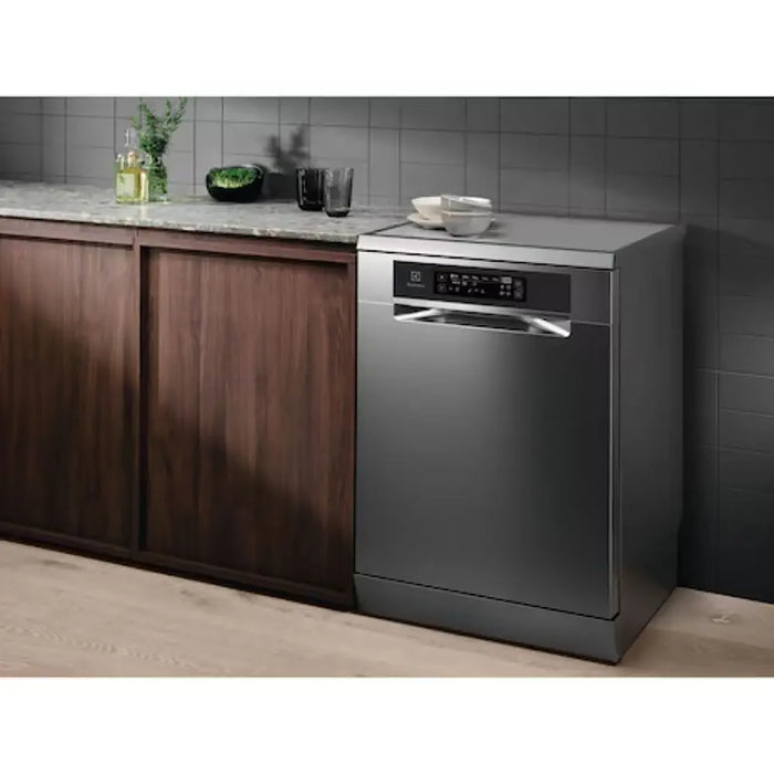 Stainless steel dishwasher in a modern kitchen with wooden cabinets and gray tiled walls.