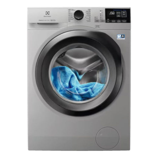Silver washing machine with a blue towel inside on a white background