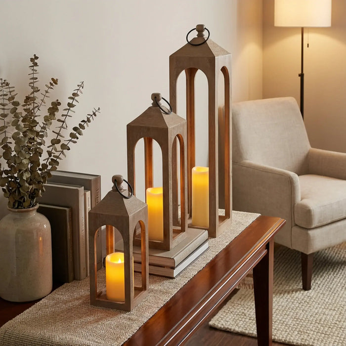 Decorative wooden lanterns with candles on a table in a living room setting.
