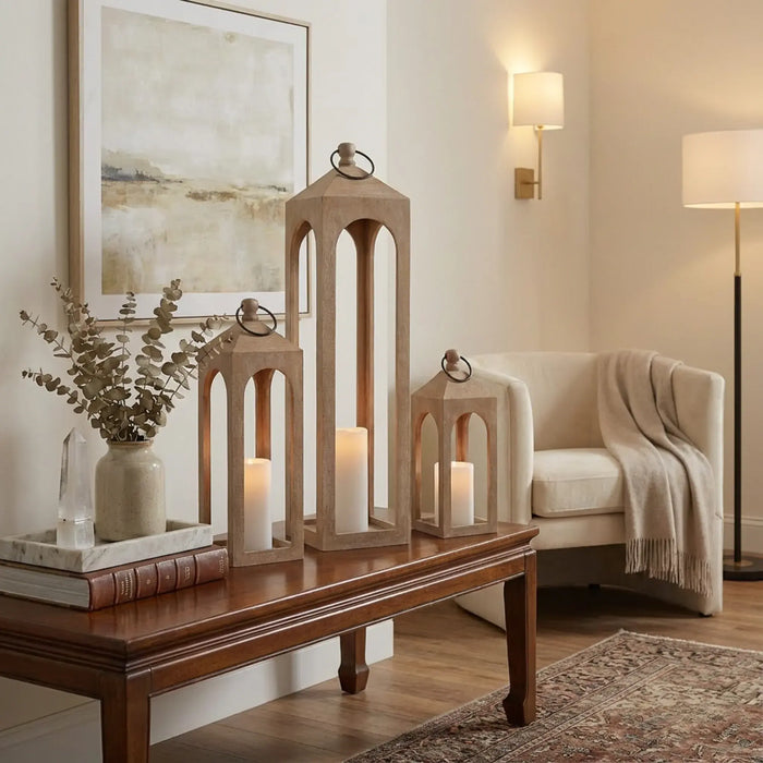 Living room with wooden lanterns, candles, and a beige armchair.