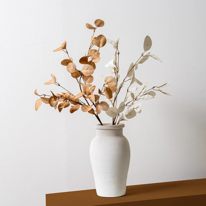 White vase with dried branches on a white background