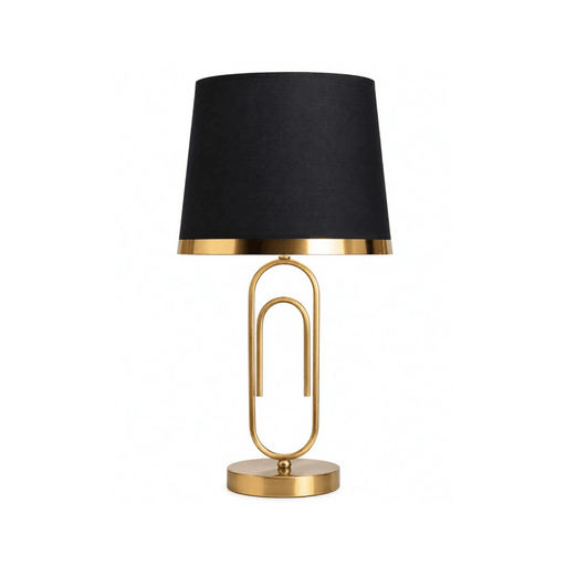 A modern table lamp with a black fabric drum shade, a gold metal paperclip-shaped stand, and a round gold base, shown on a plain white background.