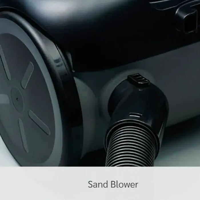 Close-up of a sand blower with visible branding on a dark background