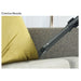 Crevice nozzle of a vacuum cleaner cleaning under a yellow pillow on a gray couch.