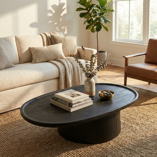 Living room with a beige sofa, brown armchair, and a dark wooden coffee table.