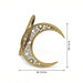 Gold crescent moon-shaped ring with intricate design, shown with measurements on a white background.