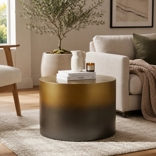 Gold coffee table in a living room with books and a plant