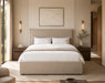 Neatly made bed in a modern bedroom with neutral tones