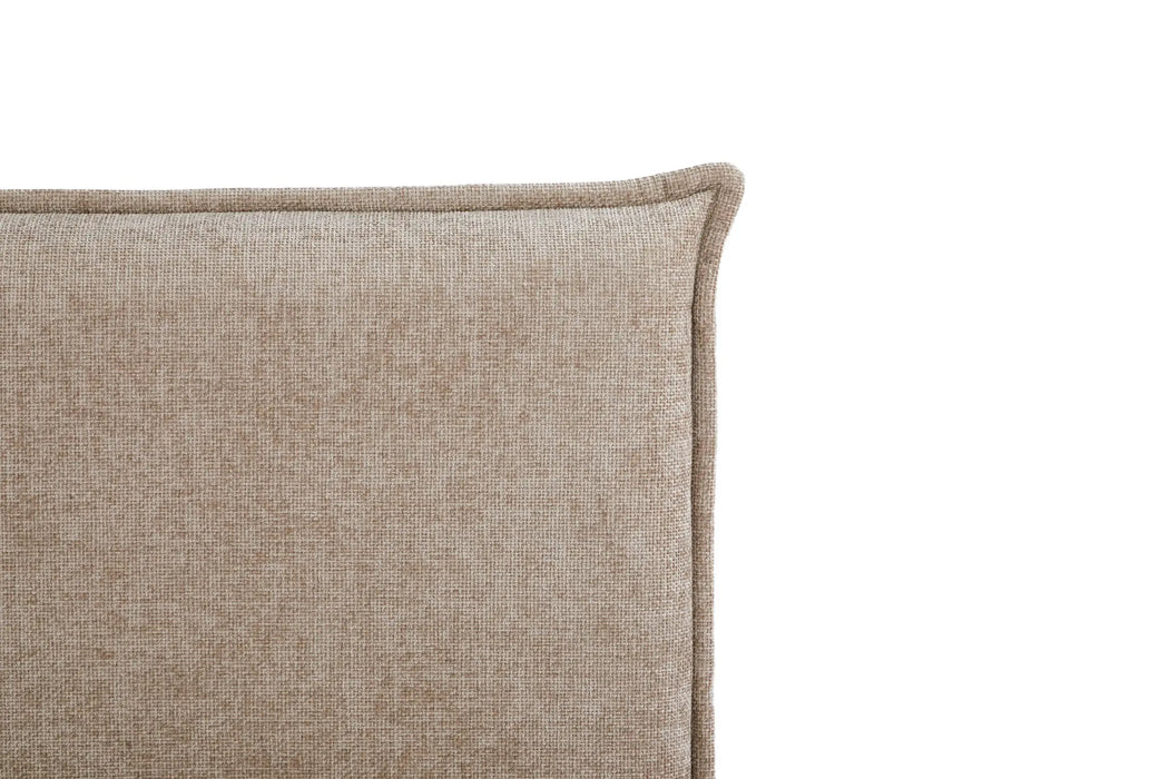 Close-up of a textured beige cushion on a white background